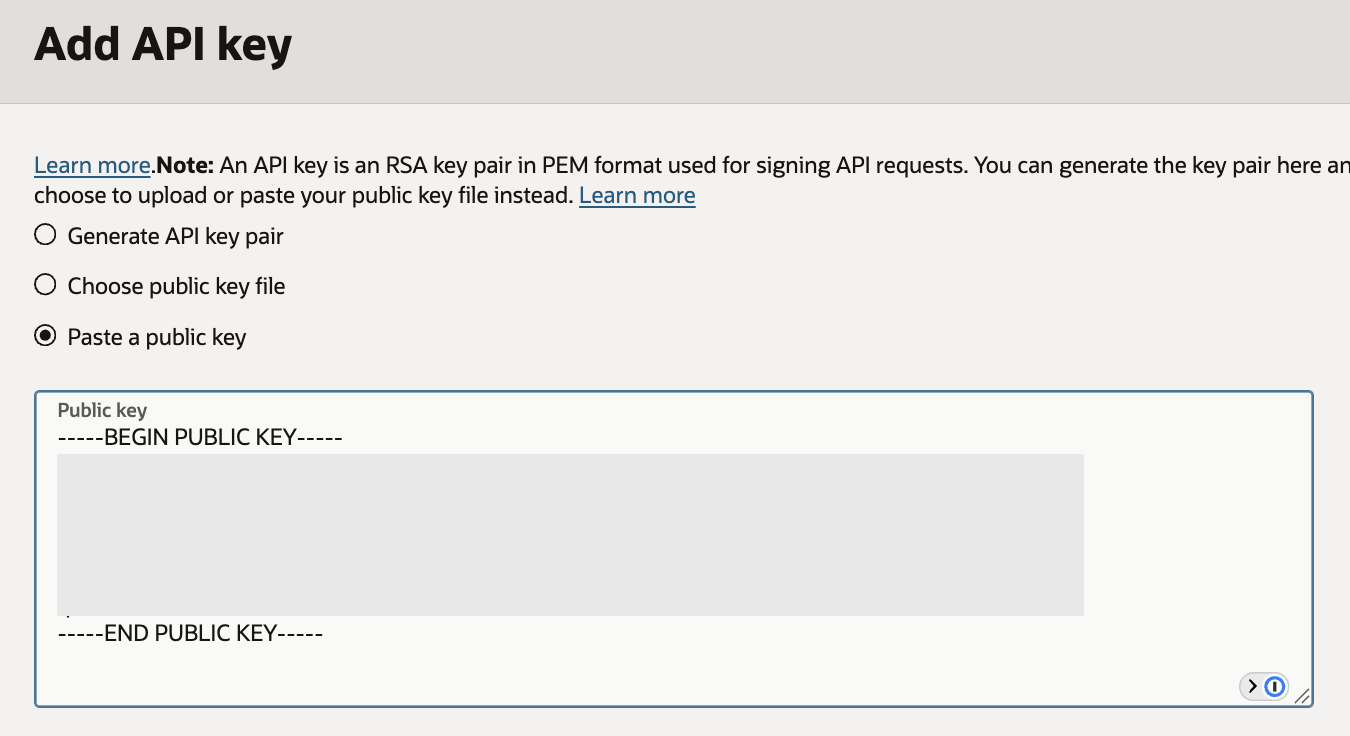 OCI Add API key dialog with Paste a public key selected and the public key content hidden